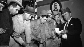A group registers for military selective service at the state fair grounds in Dallas in 1940. The Supreme Court said Monday it would not hear a case challenging the rule that only men need to register for the draft. AP