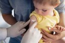 A bandage is placed on a child's arm after receiving a vaccination. State health officials have expanded eligibility for the measles, mumps, and rubella (MMR) vaccine, allowing infants as young as 6 months in areas with active spread to receive an elective dose.