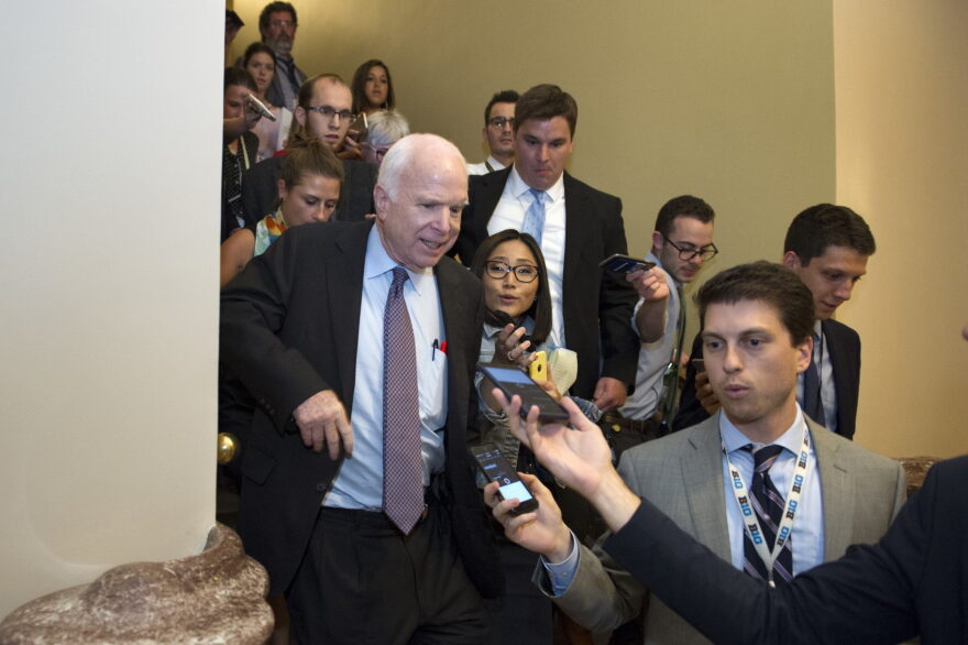Sen. John McCain, R-Az., front left, is pursued by reporters after casting a "no" vote on a measure to repeal parts of former President Barack Obama's health care law, on Capitol Hill in Washington, Friday, July 28, 2017. (Cliff Owen/AP)