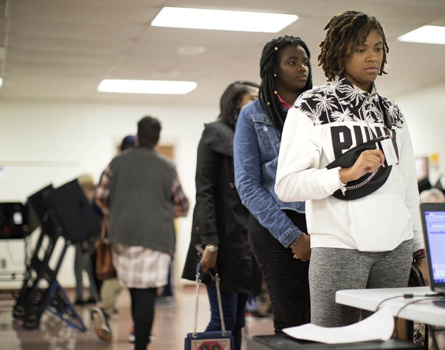 Bennett College students, Nia Watson, right, Ariel Tindle and Destiny Edward wait in line to vote early at Brown Recreation Center on Friday, Oct. 19, 2018, in Greensboro, N.C. 