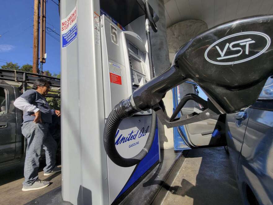 A motorist pumps gasoline at United Oil gas station in Los Angeles Friday, Aug. 12, 2022. The average U.S. price of regular-grade gasoline plummeted 45 cents over the past two weeks to $4.10 per gallon. Industry analyst Trilby Lundberg of the Lundberg Survey said Sunday, Aug. 14, 2022, that the continued decline comes as crude oil costs also remain low. (AP Photo/Damian Dovarganes)