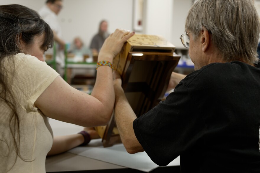 David Moulten and his wife worked on a Japanese puzzle box Thursday.