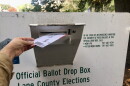 An Oregon voter makes use of one of many official ballot drop boxes across Lane County.