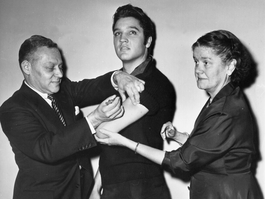 Elvis Presley receives a polio vaccine in New York City in 1956 in an effort to inspire public confidence in the vaccine. The Ad Council says it will be recruiting trusted influencers for its campaign around the coronavirus vaccine.