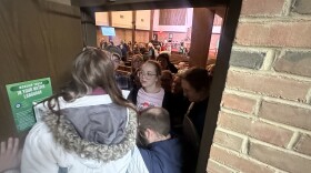 During a Rapid Response scenario, community members work together to stop a pretend 'ICE' agent from entering church sanctuary. According to the scenario, undocumented immigrants are sheltering inside.