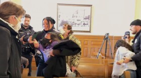 Syracuse police officers remove two protesters from a Syracuse Common Council meeting on Monday, February 9, 2026.