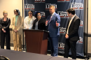 Eaton County Prosecuting Attorney, Republican Doug Lloyd, second from the right, criticizes his Democratic opponent in the race for Michigan attorney general of advocating a policy that "ignores the realities of the sex trade."
