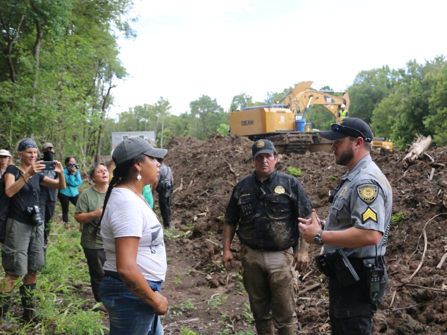Sheriff's deputies negotiate with protesters who have disrupted construction of the Bayou Bridge Pipeline. No arrests were made on this day, but at least 10 protesters could face felony charges.