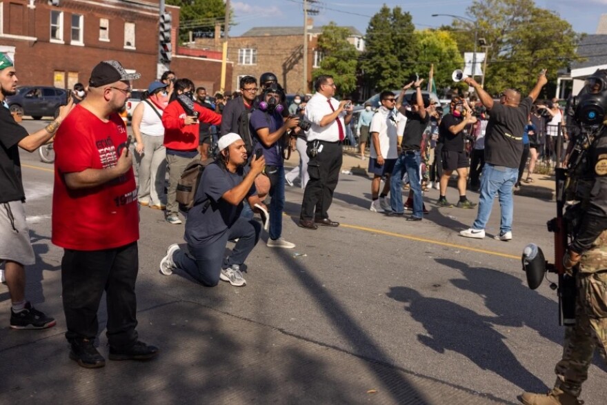 People protest Saturday near 39th Street and Kedzie Avenue, where U.S. Border Patrol agents shot a woman who they say was following them in a convoy of other vehicles. The woman was treated at a hospital and taken into custody.