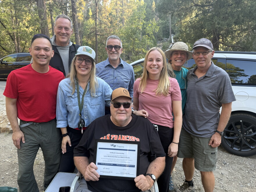 UCSF Fresno faculty gather around Dr. Weichenthal's husband, Dan Wolfe, after renaming the program as the Lori A. Weichenthal Wilderness Medicine Elective.