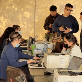 Regional Center for Border Health employees help migrants make travel arrangements at the organization's headquarters in Somerton.
