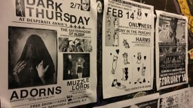 Super Dark Collective gig posters displayed at Desperate Annie's in Saratoga Springs