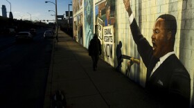 A person walks past a mural of Martin Luther King in Philadelphia, Friday, Jan. 18, 2008. Monday, Jan. 21, 2008 is Martin Luther King Day. (Matt Rourke/AP)