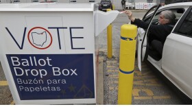 A voter drops of his election ballot in the drop box at the Cuyahoga County Board of Elections, Wednesday, April 22, 2020, in Cleveland.