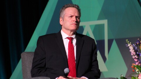 Gov. Mike Dunleavy listens to Glenfarne CEO Brendan Duval talk about the Alaska LNG Project during a panel on Thursday, June 5, 2025 in Anchorage, Alaska.