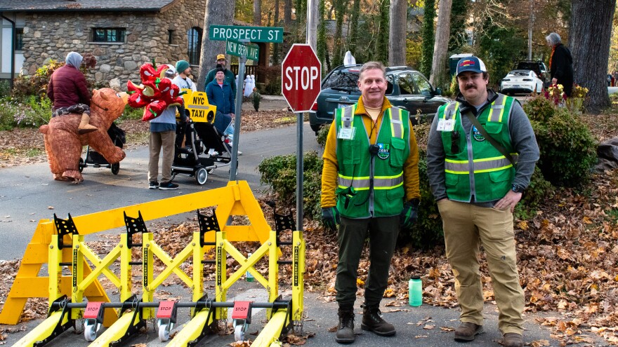 CERT volunteers John Bagot and J.D. Jorgensen hold down one of the barricades to keep cars away from the streets where kids were trick-or-treating.