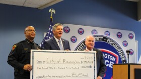From left, Bloomington Police Chief Jamal Simington, U.S. Rep. Darin LaHood and Bloomington Mayor Dan Brady pose with a ceremonial check acknowledging a nearly $600,000 federal grant used to upgrade the department's Real-Time Information and Crime Center.
