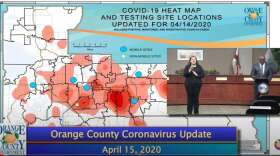 Orange County mayor Jerry Demings gives an update next to a 'heat map' displaying zip codes with high concentrations of coronavirus cases. Image: Orange TV