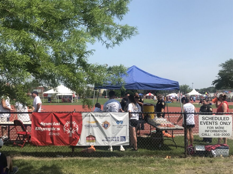 a fence and field with Special Olympics signs.