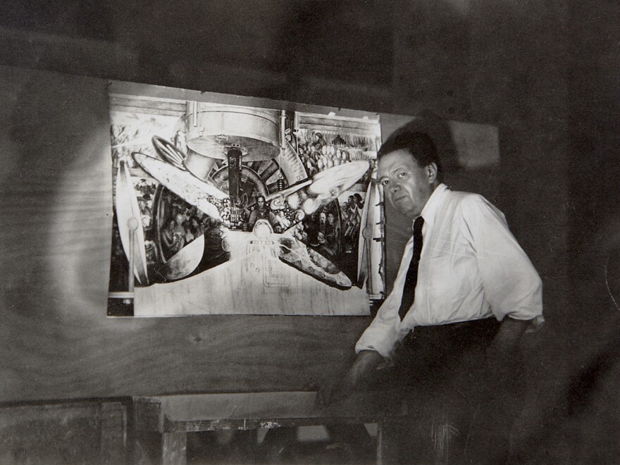 Artist Diego Rivera stands with a copy of the mural he painted at Rockefeller Center that was eventually destroyed.