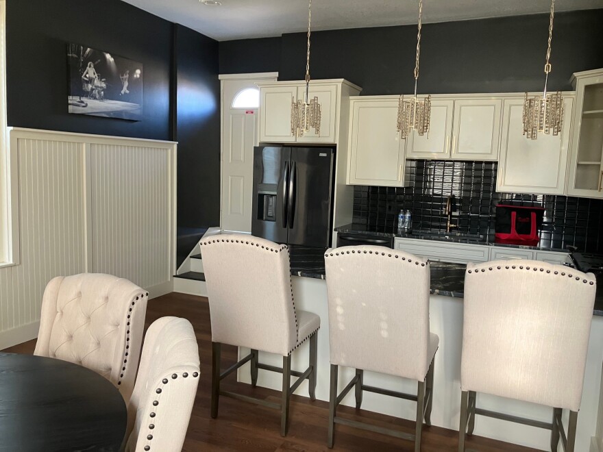 The renovated kitchen on the second floor of Hose Station No. 7 features black-and-white concert photos of iconic musical acts, like The Beatles and The Who.