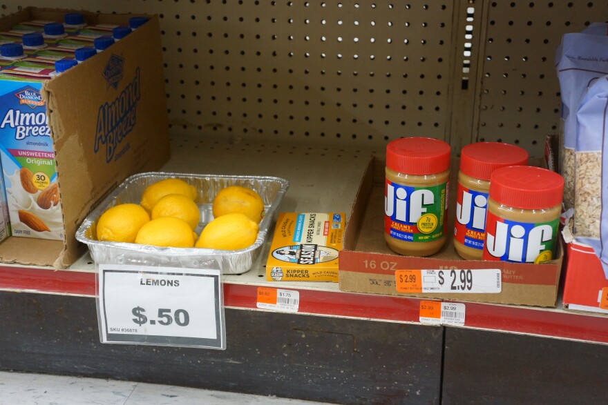 A box of lemons on a shelf next to Jif peanut butter