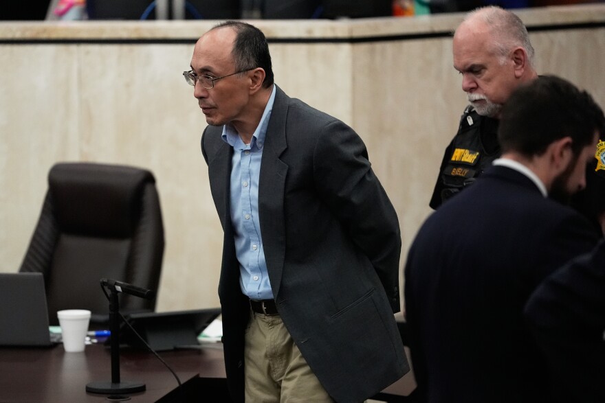 Chikei Rick Chow, left, accused in the 2023 fatal shooting of a Black 14-year-old, is escorted in the courtroom during his murder trial, Friday, May 29, 2026, in Columbia, S.C. (AP Photo/Erik Verduzco)