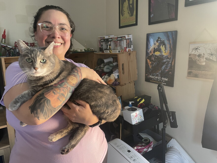 Angel Desrocher, 36, with her cat Bento. She's rented apartments since she graduated college, but she is envious of adults who decided to live at home and build up their savings.