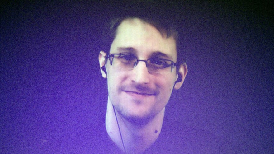 Former U.S. National Security Agency contractor Edward Snowden, shown broadcasting from Moscow in 2014, says he acted as a whistleblower when he shared classified documents with journalist Barton Gellman.