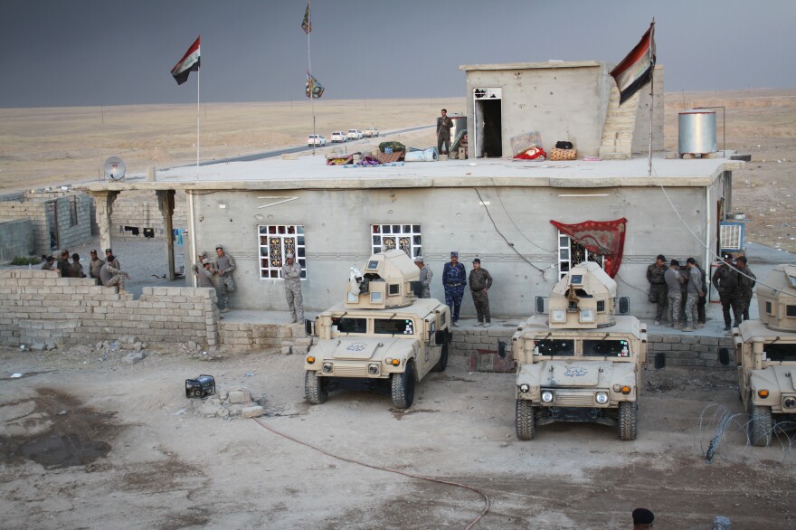 Police meet in the village of Mahana, which was retaken from the Islamic State a few months ago. The police have been training and hope to return to their home city of Mosul soon.