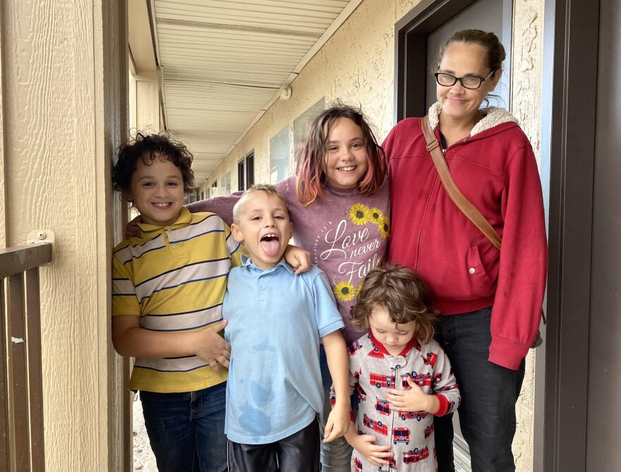 Kathleen Barnes and four of her children stand outside their motel room at the Welcome Inn in Blue Springs.