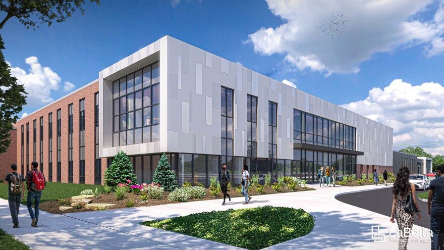 A rendering of a rectangular building with white stone and ample glass on one side, and orange brick with windows on another.