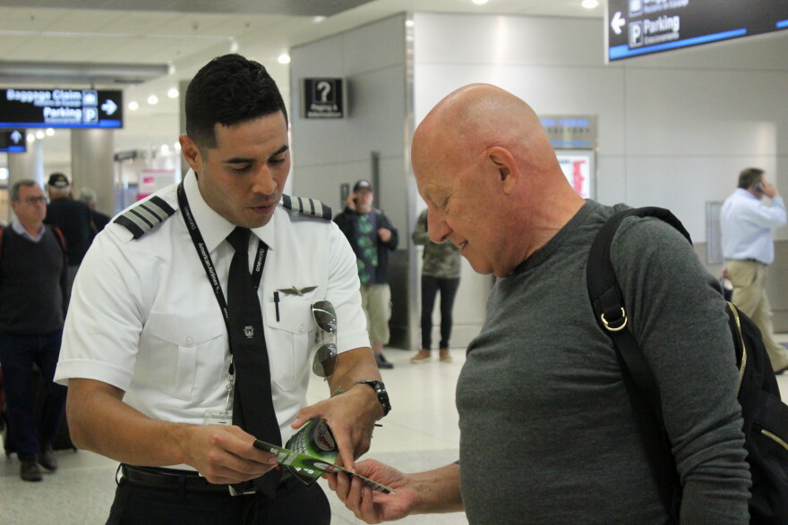 Local members of the National Air Traffic Controllers Association stop passengers to talk about the impact of the government shutdown on airport workers in the Miami International Airport on Wednesday, Jan. 16, 2019.  
