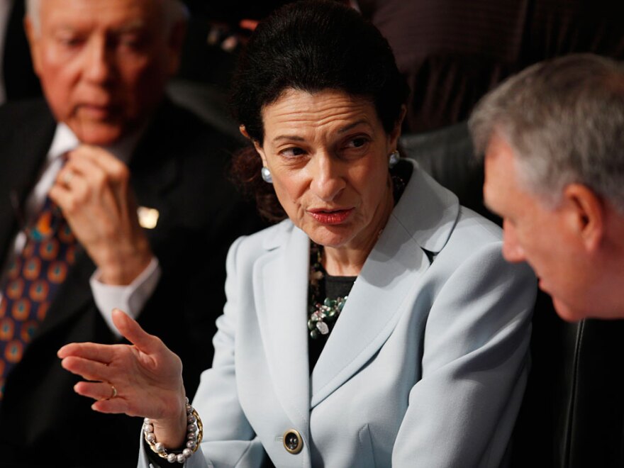 Senate Finance Committee member Olympia Snowe (R-ME) confers with fellow committee member Jon Kyl (R-AZ) as Orrin Hatch (R-UT) looks on during the committee's Tuesday hearing regarding health care.