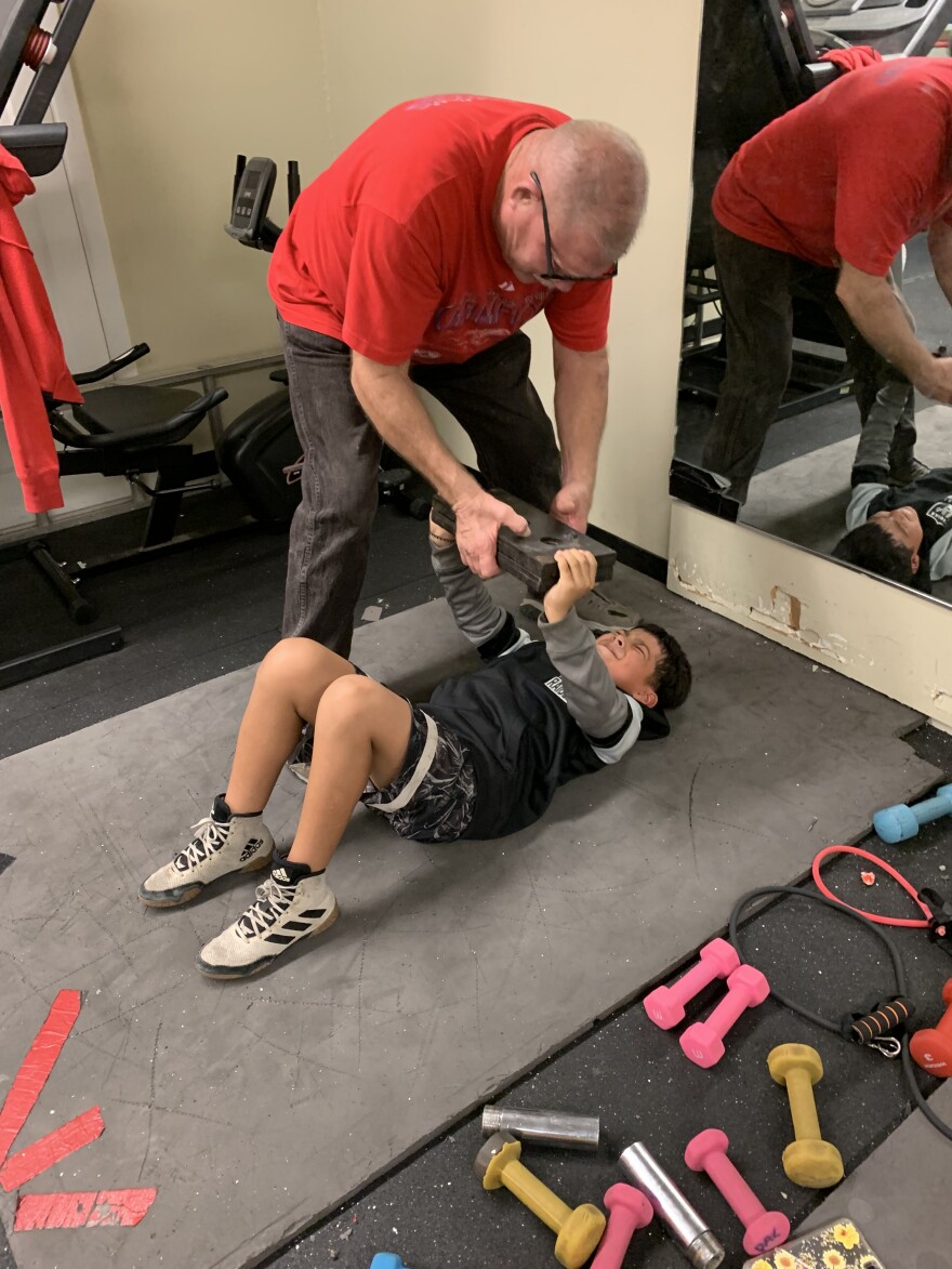 Coach Ray helps Jordan do bench presses