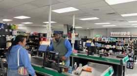 Hameed Bello, co-owner of Farm Store 99 in Downtown Springfield, Ma., serves a customer recently.