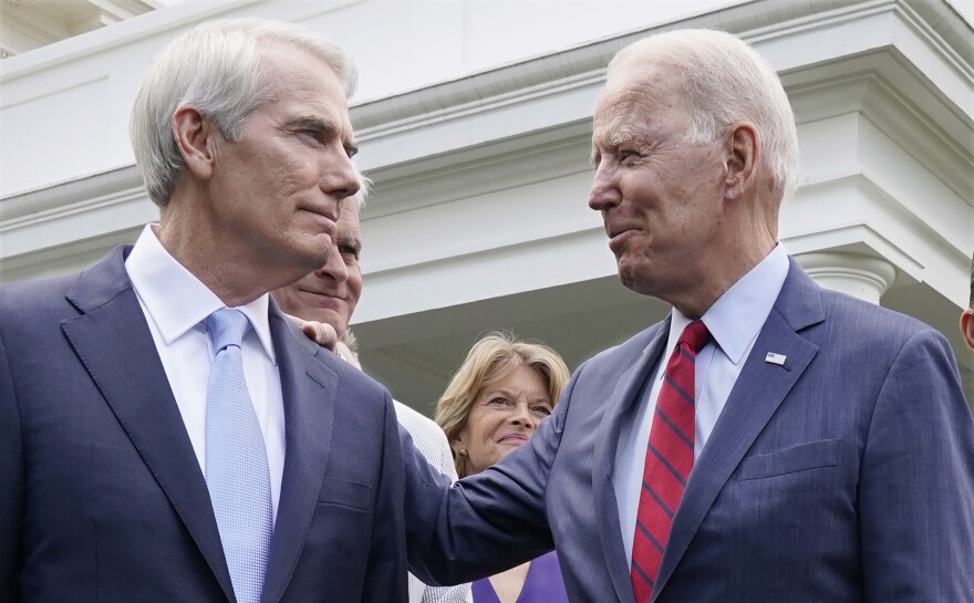 In this photo from June 24, 2021, President Joe Biden speaks with Sen. Rob Portman, R-Ohio, and other senators outside the White House in Washington after Biden invited members of the group of 21 Republican and Democratic senators to discuss an infrastructure plan. Portman, a three-decade Washington veteran plans to retire rather than run next year. He announced in January he would not seek a third term, saying it had become too hard to get things done. 