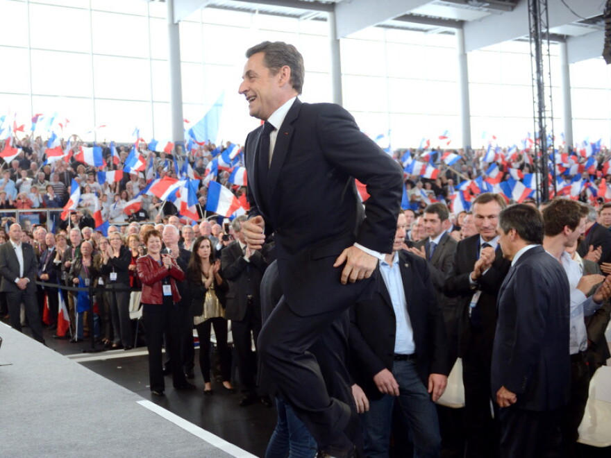 France's incumbent President Nicolas Sarkozy arrives on stage to deliver a speech during a campaign meeting in Cernay, eastern France, on April 25, 2012. Sarkozy will face his rival Socialist Party Francois Hollande in a final round on May 6, 2012.