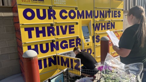 Two Second Harvest Food Bank staff load up the organization's outdoor, 24/7 food lockers