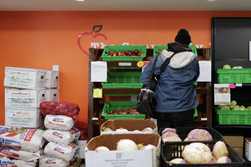 A resident picks up fresh produce at the Berkley food hub.