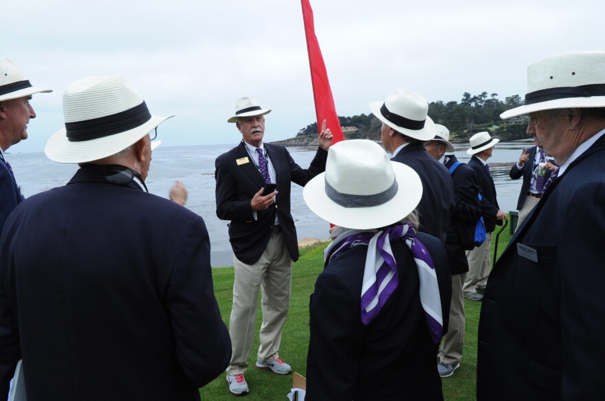 Wayne Craig (center) gives last-minute instructions to the volunteer docents who lead tours and have knowledge of the cars.