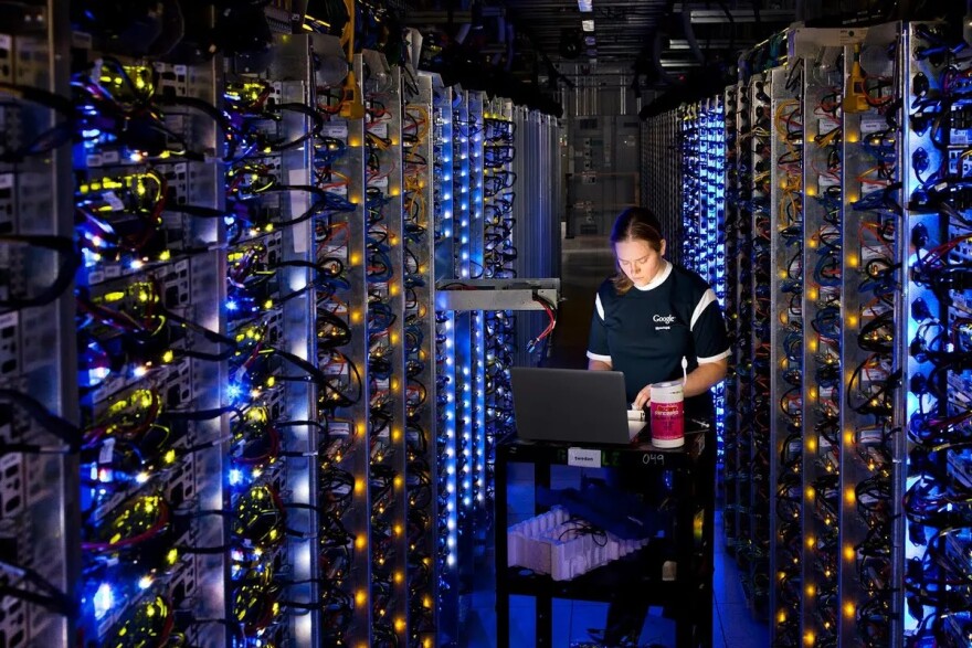This photo provided by Google shows a Google technician working on some of the computers inside a data center.