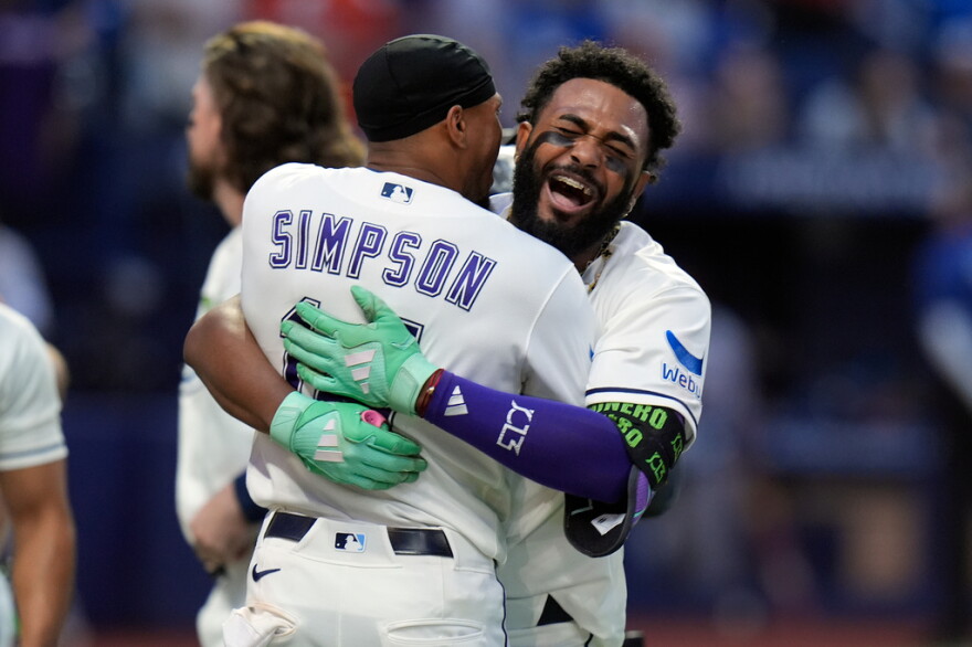 Junior Caminero celebrating with Chandler Simpson after the Tampa Bay Rays clinched a 2026 postseason spot