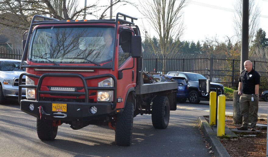 State Preparedness and Incident Response Equipment (SPIRE) Grant Program Coordinator Jim Jungling (right) inspects one of the new EarthCruiser all-terrain CORE Vehicles.