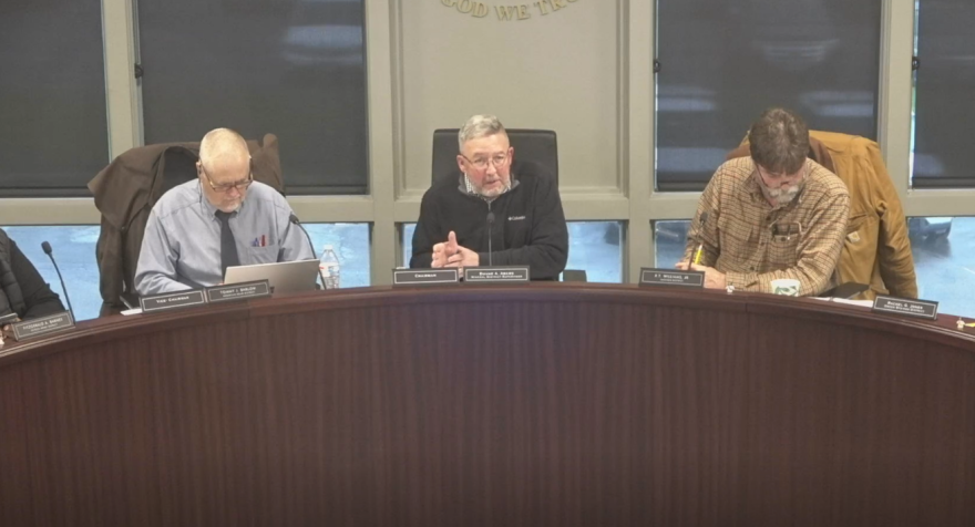 Louisa County Board of Supervisors Chair Duane Adams, center, speaks out against the transmission line proposal in a March 16 meeting.