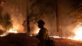 Firefighters protect homes in Christmas Valley from the Caldor Fire Monday, Aug. 30, 2021.