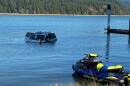 Lincoln County Sheriff's deputies rescued a man who'd become trapped in his vehicle after crashing into Alsea Bay Thursday.