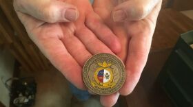 James Hunt, the judge advocate at Florissant Valley Memorial Post 444, holds a military funeral honors coin. Hunt is a member of the post's honor guard.