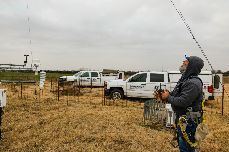 Meteorological Electronics Technician Kirk Wilson eyes the top of a 30-foot tower as he prepares to replace a wind sensor at an Oklahoma Mesonet station near Shawnee, Okla.