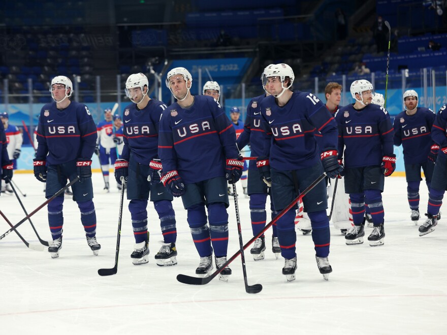 Team USA reacts after losing to team Slovakia in a penalty-shot shootout during the men's ice hockey quarterfinal match against Team Slovakia at the Beijing 2022 Winter Olympic Games.